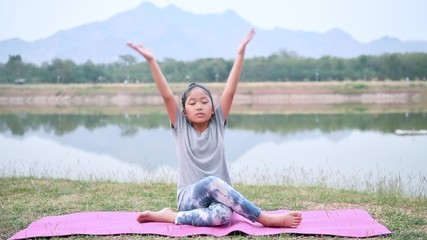 Wall Mural - Cute girl is playing yoga or exercise on mat. Healthy and sport concept