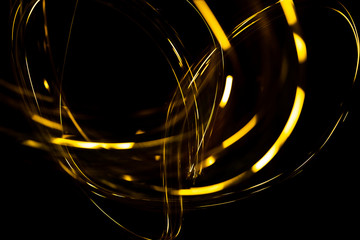 Wall Mural - abstract texture of Golden sparkles on a black background, Golden highlights in the form of spirals and iridescence