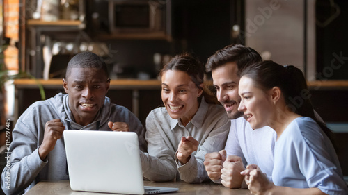 Cuadros en Lienzo Excited diverse friends cheering watching match on laptop online