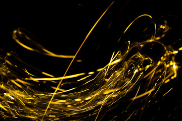 Wall Mural - abstract texture of Golden sparkles on a black background, Golden highlights in the form of spirals and iridescence