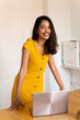 © Westend61 - Portrait of smiling businesswoman with laptop in office
