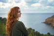 © Westend61 - Redheaded young woman at the coast, Ibiza, Spain