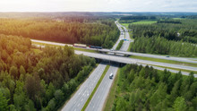 Aerial View Of The Road With Bridge And Forest In Summer Sunny Day. Highway In Finland.