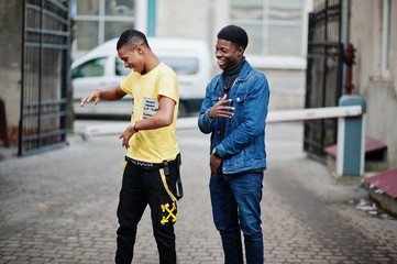 Two african male friends dancing together.