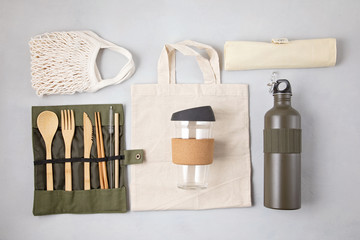 Zero waste kit. Set of eco friendly bamboo cutlery, mesh cotton bag, reusable coffee tumbler and water bottle. Sustainable, ethical, plastic free lifestyle.