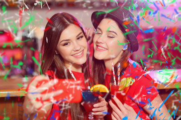 Confetti party. Two young girls lesbians at a party in the club take a selfie.