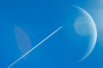 Wall Mural - conversion track from a rocket in the blue sky. moon with a large increase. space, rocket flies to t