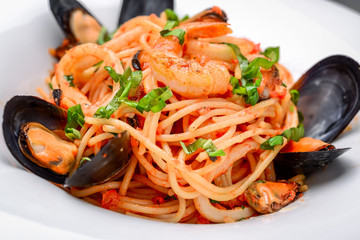 Wall Mural - pasta with shrimp and mussels, tomato sauce, basil and grated parmesan cheese