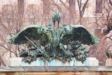 City landscape - view of the bronze statue closeup of the coat of arms of the Austrian empire in the city of Vienna, Austria