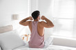 © New Africa - Man awakening on bed at home. Lazy morning