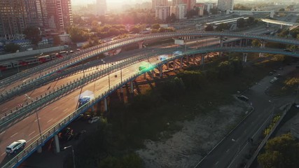 Wall Mural - Amazing aerial presentation of the autonomous cars self-driving concept on the sunny evening in Moscow. Beautiful view from above to the road traffic on multi-level highway of big city.