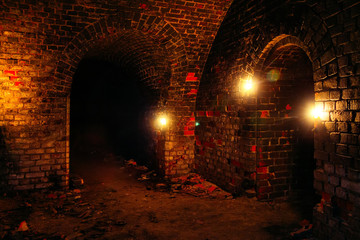 Dark dungeon under the old german fortress illuminated by candles