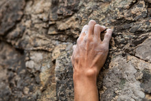 A Close Up Shot On The Fingers Of A Male Rock Climber, Struggling To Find A Stable Grip Position On Steep Crag. Hold Positions In Natural Stone Cracks