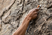 A Close Up View Of Advanced Rock Climbing Gear In Use As The Hand Of A Man Grabs Onto A Secured Belay Device, Health And Safety During Risky Sport