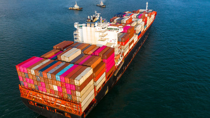 Aerial view container ship carrying container in import export business logistic and transportation of international by container ship in the open sea.