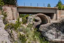 Old Bridge Over A Stream With An Arch Below