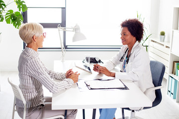 Wall Mural - Mature woman with her doctor in ambulance talking about healthcare