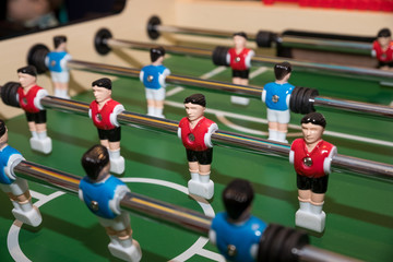 Wall Mural - Friends Playing Table Soccer Game. table football or kicker with miniature players. game table. Games, entertainment, hobbies and leisure.foosball.plastic players in the table soccer.game kicker