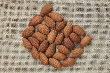 Wall Mural - Close up almond nuts natural protein food and for snack - Almonds on sack background