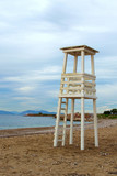 Fototapeta Las - White wooden lifeguard tower on the municipal beach in Glyfada. Winter landscape. Glyfada is a suburb in South Athens located in the Athens Riviera