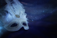 Photo Of Elegant And Delicate White Venetian Mask Over Purple Silk Background
