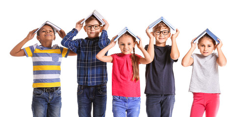 Cute little children with books on white background