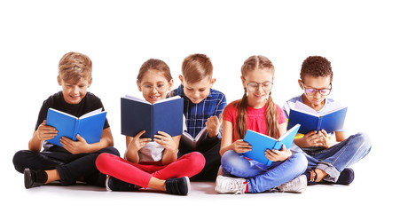 Cute little children reading books on white background