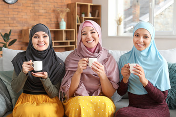 Sticker - Beautiful young Muslim women drinking tea at home