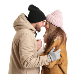 Wall Mural - Portrait of happy couple in winter clothes on white background