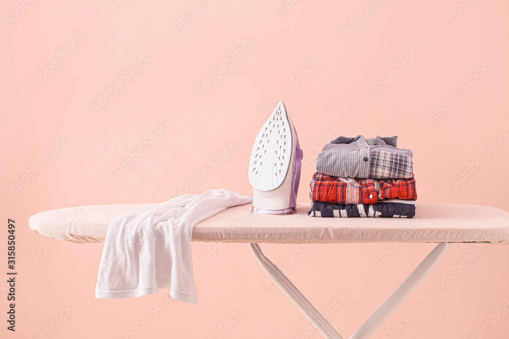 Electric iron and board near color wall