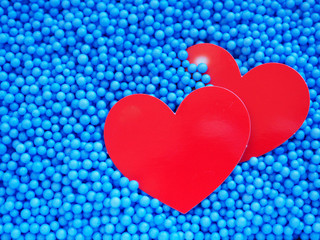 Two red heart on small blue foam balls background, Concept Valentine's day and     Anniversary..