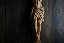  Cruciefied Jesus Figure Isolated On Rustic Dark Brown Table.