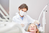 Fototapeta Panele - Dentist with surgical mask during treatment
