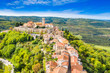 Beautiful old town of Motovun, stone houses and church tower bell, romantic architecture in Istria, Croatia, aerial view from drone