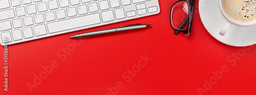 Fotografía Office red workplace with coffee cup, supplies and computer