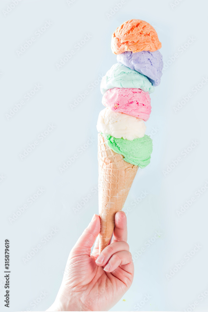 Stack of pastel colorful ice cream scoops in waffle cone, isolated on ...