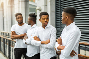 Wall Mural - four handsome young african men in white shirts