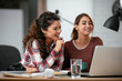 © JustLife - Two friends working together. Colleagues having fun in office.