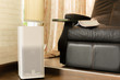 Electric air purifier in a living room for cleaning fine dust in house.