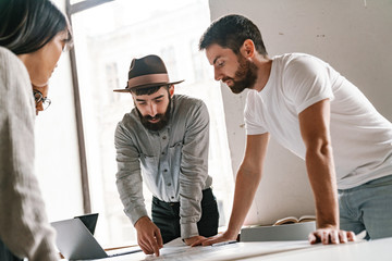 Wall Mural - Image of multiethnic young business people working together at office