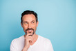 © deagreez - Close-up portrait of his he nice attractive curious cheerful dreamy guy thinking creating new idea touching chin isolated over bright vivid shine vibrant teal green blue turquoise color background