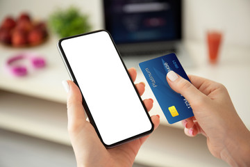 female hands holding phone with isolated screen and credit card
