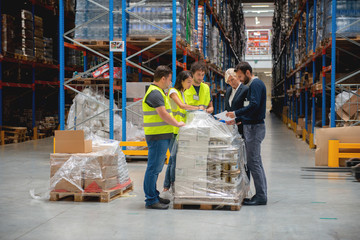 Warehouse staff meeting, workers with mnagers