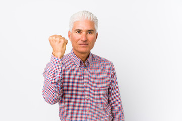 Senior caucasian man isolated showing fist to camera, aggressive facial expression.