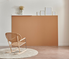 Brown and white wall background, chair frame book and vase of plant in the room.