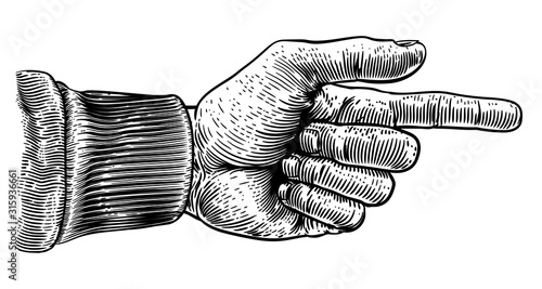 A hand pointing a finger in...