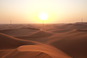 Wall Mural - Desert sunrise with power transmission towers and lines for solar energy concept. Riyadh, Saudi Arabiar 