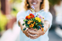 Spring Flowers And Free Happiness Concept - Unrecognizable Defocused Caucasian People Woman Taking And Showing A Group Of Coloured Fresh Flowers In Front Of The Camera