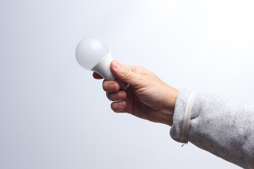 Energy saving light bulb in the hand of an adult