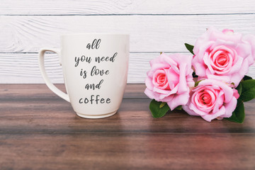 Wall Mural - Inspirational quotes - all you need is love and coffee. Coffee mug and pink roses